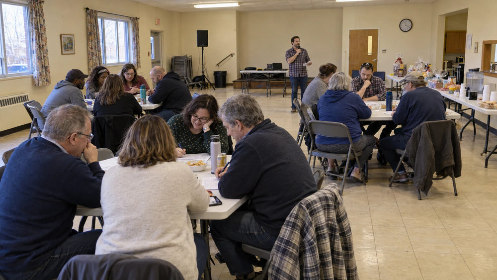 Supporters enjoying a community fundraising quiz with a volunteer host