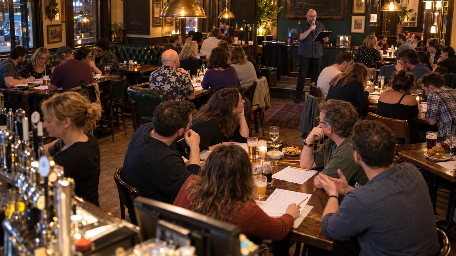 Fictional crowded pub quiz with occupied team tables, players writing answers and a host at the far end