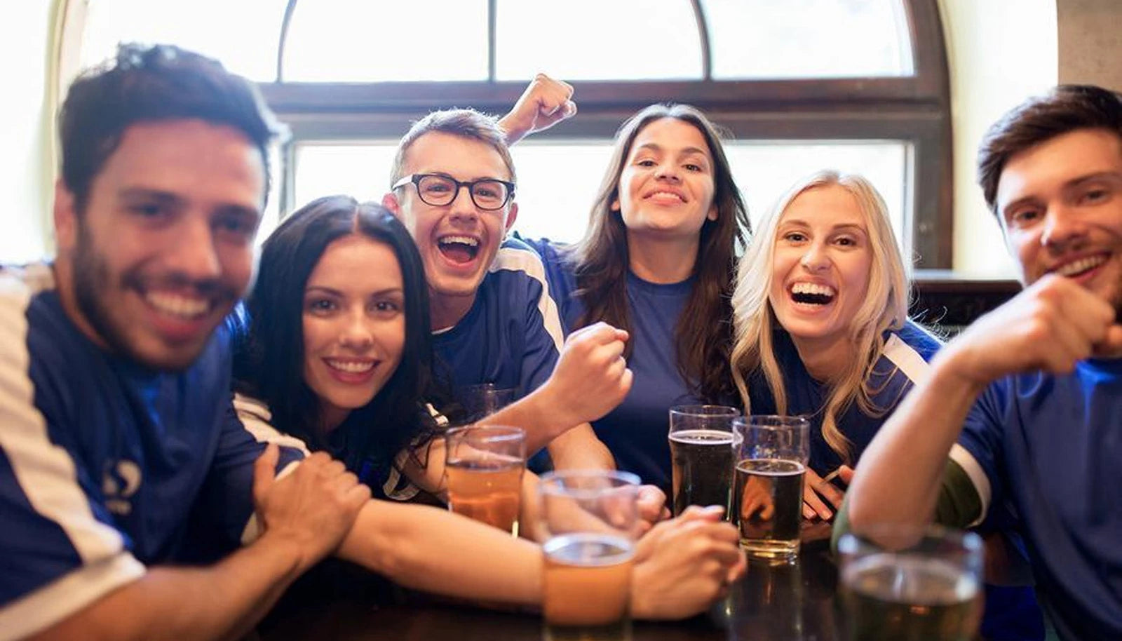 Original article photograph of friends gathered around a pub table