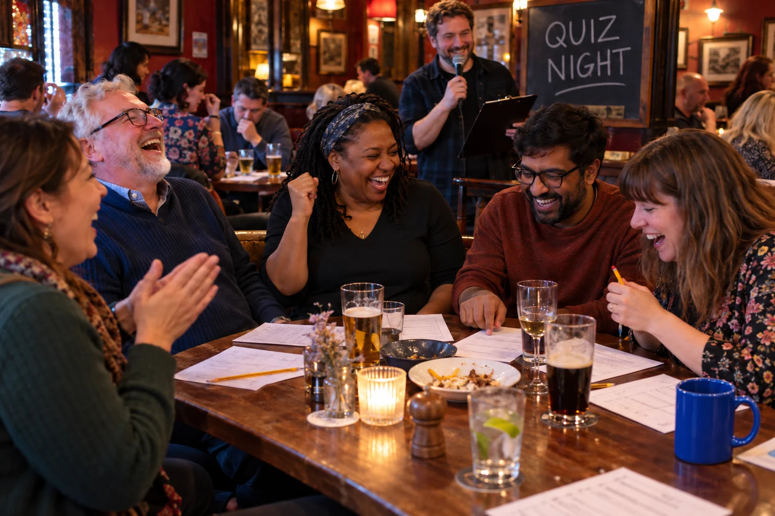 Fictional pub quiz team reacting with delight to a correct answer while their host continues the round