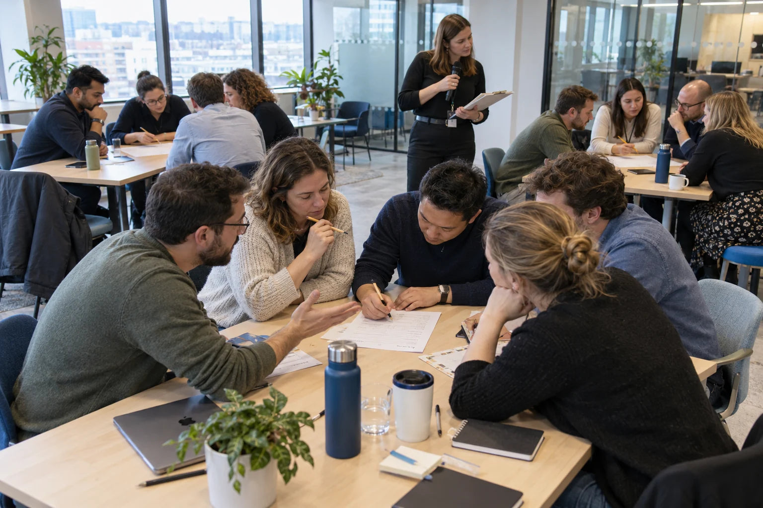 Fictional office teams collaborating on a trivia round in a bright modern workspace